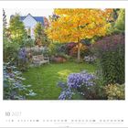 10 2027. Ein bunter Garten mit Sitzbank und einem Baum mit gelben Blättern im Herbst.