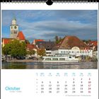 Text: Oktober, 3.10. Tag der Deutschen Einheit, 31.10. Reformationstag. 

Illustration: See, Schiff, Gebäude mit Turm, blauer Himmel.