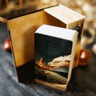 "Tarot" auf einer Kartenbox. Eine Karte zeigt eine Person auf einem fliegenden weißen Drachen gegen einen sternenklaren Himmel.