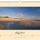Kalenderseite für Oktober mit einem Bild eines breiten Sandstrandes bei tief stehender Sonne.