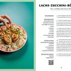 Lachs-Zucchini-Röllchen Rezept, Zutatenliste: Lachs, Zucchini, Sojasauce. Bild: Hand greift nach Röllchen auf Reis.