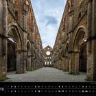 Die Texte unten links und rechts lesen "Toskana 10" und "Ruinen der Abtei Abbazia San Galgano". Über diesen Texten sind Ruinen einer gotischen Abtei zu sehen, mit hohen Arkaden und einem offenen Himmel.