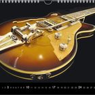 Ein Kalenderblatt zeigt im Oktober eine braune E-Gitarre mit glänzenden Metallteilen auf schwarzem Hintergrund.