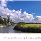 „Greetsiel Windmühle“, Monatsübersicht für November. Eine malerische Landschaft mit Windmühle, Wasser und grünen Wiesen.
