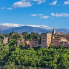 Keine Texte vorhanden. Historische Festung auf einem Hügel vor schneebedeckten Bergen und blauem Himmel.