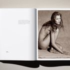 Links: Kleiner, zentral platzierter Text. Rechts: Schwarz-Weiß-Foto einer sitzenden, nachdenklichen Frau auf sandigem Untergrund.