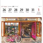 Kalender der Woche vom 26. Juli bis 1. August. Bild: Süßwarengeschäft in Banff, Alberta mit rosafarbenem Fahrrad davor.