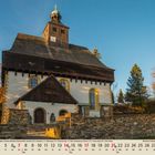 "11" unten links. Eine Kirche mit markantem Turm in herbstlicher Landschaft, umgeben von Bäumen und Steinmauern.