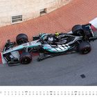 "November, GP Monaco (Monte Carlo)" steht unten. Ein silberner Formel-1-Wagen fährt auf einer Strecke mit roten Bordsteinen.