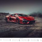 Der Text "NOVEMBER" und "Lamborghini Revuelto" erscheint. Ein roter Sportwagen steht auf rauem Asphalt vor nebligen Hügeln.