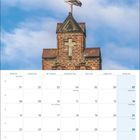 Kalenderseite für November 2027 mit Feiertagen. Ein Storch steht auf einem Backsteingiebel vor blauem Himmel.