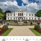 Kalenderseite mit Datum Mai 2027, zeigt die Villa Hammerschmidt in Bonn, Menschen spazieren im Garten, blauer Himmel.