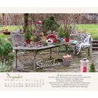 "Stilleben. Bianka Bleier. Dezember. Im Spiel erholt sich unsere Seele."  
Gartenszene: Tisch mit Zapfen, Kerzen, Kranz.
