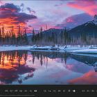 "Bow River bei Sonnenaufgang, Alberta, Kanada", darunter eine verschneite Landschaft mit spiegelndem Fluss und Bergen bei Sonnenaufgang.