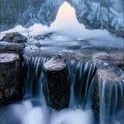 Dezember 2021, mit Kalenderdaten darunter. Landschaft mit Bergen, See und einem kleinen Wasserfall im Vordergrund.