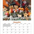 Kalenderblatt für Dezember mit Äpfeln, Gebäck und Tannenzweigen verziert. Feiertage wie Nikolaus, Weihnachten, Silvester.
