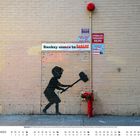 "Banksy comes to ZABARS". Graffiti-Illustration eines Jungen mit Hammer auf Backsteinwand, darüber diverse Hinweisschilder.