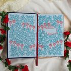 Text: "This book belongs to:" in einem Rahmen. Florales Muster mit roten Blumen und grünen Blättern, umgeben von roten Rosen.