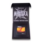 "RELOAD", "METALLICA", "A WHOLE 'NOTHER SINK" in einer geöffneten Box. Darin ein Albumcover mit flammenden Farben.