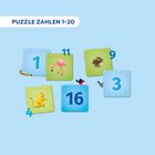 "PUZZLE ZAHLEN 1-20": Verschiedene bunte Felder mit Zahlen und Tieren wie Flamingo, Hase und Löwe auf hellblauem Hintergrund.