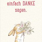 "Ich möchte einfach DANKE sagen." Ein Hase hält einen Blumenstrauß. Der Hintergrund ist mit Mustern gestaltet.