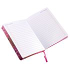 Text "DON'T FORGET" oben auf beiden Seiten eines geöffneten, floral gebundenen Notizbuchs mit Punkterasterlinien.