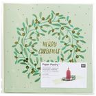 Text: "Merry Christmas", "Paper Poetry", "Pop-Up Karte + Umschlag". 
Illustration: Mistelkranz in Grün und Gold.