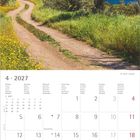4 · 2027. Kalender mit April-Daten. Oben ein Pfad durch grüne Wiesen, eingerahmt von Bäumen, mit Meerblick.