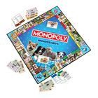 "MONOPOLY HUNDEBABYS" steht in der Mitte, mit Fotos von Welpen um den Rand. Es handelt sich um ein Brettspiel.