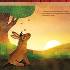 Text: "This was Ugo’s favorite moment of the day—when his belly was full and he was free to listen to the music of nature."

Ein Esel sitzt mit entspanntem Ausdruck vor einem Sonnenuntergang, Schmetterlinge fliegen umher.