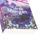 Text: "Sarah Morgan, Ein Fest für uns alle, Roman". Ein Buchcover mit floralen Illustrationen in lila und pinken Tönen.