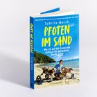 "Pfoten im Sand. Wie ich auf Koh Samui ein Zuhause für behinderte Hunde schuf." zeigt Frau mit Hunden am Strand.