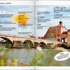 „Zahlen, bitte!“ Überschrieben steht ein Foto von Regensburgs historischem Brückentor und Steinerner Brücke im Sonnenlicht.