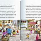 „Du lieber Rabatzki!“, rief Hauptmann. Eine bunte Stadt mit Marktständen, Menschen, einem Karussell und einem Riesenrad.