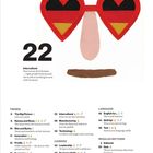 Herzförmige Brille mit Deutschlandflaggen-Design über einer Inhaltstabelle mit Themen wie Trends, Karriere und Sprache.