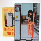 Im Vordergrund eine Frau auf Küchentheke. Hintergrund: "Olivia Har" und "Diese Sa mit Un" auf einem gelben Buchcover.