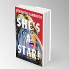 Text: "Meredith Hambrock, She's a Star!, Roman".  
Illustration: Frau mit ausdrucksstarkem Gesicht und weit geöffneten Augen.