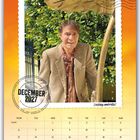 "DECEMBER 2027", "Leaking umbrella!" Ein Mann im Anzug steht unter einem undichten Schirm mit tropfendem Wasser.