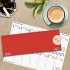 Kalenderblätter für Januar 2027, Notizblock mit "1 Woche 1 Seite", Kaffeetasse und Stifte auf hellem Holztisch.