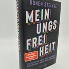 "RONEN STEINKE MEINUNGSFREIHEIT. SPIEGEL Bestseller Autor. Buntes Buchcover auf schwarzem Hintergrund."