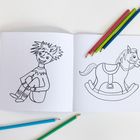 Ein Malbuch zeigt ein lachendes Kind und ein Schaukelpferd, mit Buntstiften in Blau, Grün, Rot und Gelb daneben.
