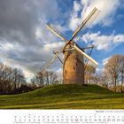Text: "Niederrhein - Geismühle in Krefeld-Opum". Eine Windmühle steht auf einem grünen Hügel mit Bäumen im Hintergrund.