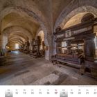 "Januar 2027: Historische Weinkeltern in einem steinernen Gewölbe mit schweren Holzkonstruktionen und Böden aus Stein."