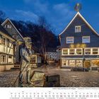 Text: "Cafe Meyer", "Stadt-Grillkeller", "Bezebäckler-Denkmal in Unterburg", Datum: "Februar 2027". Abendliche Gasse mit Statuen.