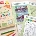 "Emmi. Mein großer Rätselblock. Ab 6 Jahren." Buntes Arbeitsbuch mit Spielen, wie Fehlersuche und Ausmalbilder, auf einem Tisch.