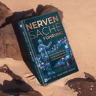 "Nervensache Führung" in Kupferschrift, darunter menschliche Figur mit leuchtenden Punkten, stützt sich auf bläulichen Objekten im Sand.