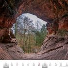 Genovevahöhle bei Kordel, Kalenderseite November 2027. Blick aus einer roten Sandsteinhöhle auf herbstliche Bäume.