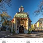 "NOVEMBER | DEZEMBER, 29, 30...12; Gnadenkapelle in Kevelaer. Kleine Kapelle, Bäume mit wenigen Blättern, blaues Himmel."
