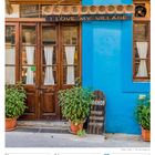 "I Love My Village" auf einem Schild. Unten links: "Damos Tavern Restaurant Coffee Shop". Kalender: Juni 2027.