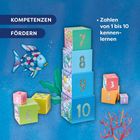 Text: "KOMPETENZEN FÖRDERN", "Zahlen von 1 bis 10 kennenlernen". Illustrationen von bunten Zahlenblöcken und einem Fisch.